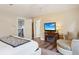 Cozy bedroom featuring a fireplace, comfortable seating, and easy access to additional rooms at 1474 S Uinta Ct, Denver, CO 80231