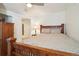 Spacious bedroom showcasing a wooden bed frame with a decorative lamp on a side table at 1474 S Uinta Ct, Denver, CO 80231
