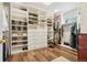 This organized walk-in closet boasts custom shelving and drawers for optimal storage at 1474 S Uinta Ct, Denver, CO 80231