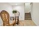 Charming dining area with elegant chairs, a glass table, and a view of the staircase at 1474 S Uinta Ct, Denver, CO 80231