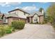 Charming home exterior featuring a three-car garage, stone and stucco details at 1474 S Uinta Ct, Denver, CO 80231