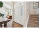 Bright foyer with staircase and elegant front door and living room view at 1474 S Uinta Ct, Denver, CO 80231