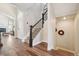 Inviting hallway with hardwood floors, a staircase, and arched doorway at 1474 S Uinta Ct, Denver, CO 80231