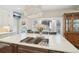 Spacious kitchen island with a cooktop, quartz countertops, and seating at 1474 S Uinta Ct, Denver, CO 80231