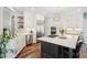 Modern kitchen with island, stainless appliances, and open layout at 1474 S Uinta Ct, Denver, CO 80231