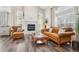 Cozy living room featuring a fireplace, large windows and wood floors at 1474 S Uinta Ct, Denver, CO 80231