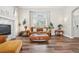 Bright living room featuring hardwood floors and cozy seating arrangement at 1474 S Uinta Ct, Denver, CO 80231