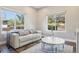 Bright living room with large windows, a sofa, and a stylish coffee table at 1474 S Uinta Ct, Denver, CO 80231