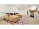 Comfortable living room with a large sectional sofa, stylish rug, and mounted television at 1474 S Uinta Ct, Denver, CO 80231