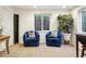 Cozy sitting area with plush blue chairs, natural light, and a decorative plant at 1474 S Uinta Ct, Denver, CO 80231