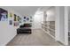 Finished basement area with cozy seating, carpet, and custom built-in shelving at 8905 Field St # 91, Westminster, CO 80021