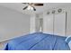 Bright bedroom with a ceiling fan, closet, and comfortable blue bedding at 8905 Field St # 91, Westminster, CO 80021