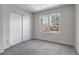 Neutral bedroom with a large window, closet, and soft carpet flooring at 8905 Field St # 91, Westminster, CO 80021
