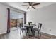 Bright dining area with sliding glass doors, hardwood floors, and modern ceiling fan at 8905 Field St # 91, Westminster, CO 80021