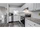 Bright kitchen with white cabinets, subway tile backsplash, and stainless steel appliances at 8905 Field St # 91, Westminster, CO 80021