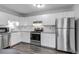 Modern kitchen with stainless steel appliances, white cabinets, and granite countertops at 8905 Field St # 91, Westminster, CO 80021