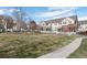 Well-manicured lawn and common green area with townhomes and pedestrian walkway at 1479 Nemrick Pl, Castle Rock, CO 80109