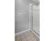 Modern shower with sleek glass doors, white tile, and chrome fixtures in well-lit bathroom at 1479 Nemrick Pl, Castle Rock, CO 80109
