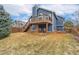 Two-story home featuring a backyard with a deck that offers outdoor living space at 6452 Freeport Dr, Highlands Ranch, CO 80130