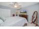 Inviting bedroom with a dresser, TV, and access to an ensuite bathroom at 6452 Freeport Dr, Highlands Ranch, CO 80130