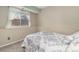 Simple bedroom with neutral decor, carpeted floors, and a bright window at 6452 Freeport Dr, Highlands Ranch, CO 80130