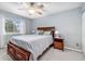 Cozy bedroom with a ceiling fan, plush carpeting, and a large sunny window at 6452 Freeport Dr, Highlands Ranch, CO 80130