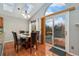 Bright dining area with sliding door access to the deck and natural light from the skylight at 6452 Freeport Dr, Highlands Ranch, CO 80130