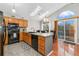 Bright kitchen featuring modern appliances, a convenient island, and a lovely skylight at 6452 Freeport Dr, Highlands Ranch, CO 80130