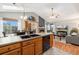 Open-concept living room featuring a cozy fireplace, dining area, and modern kitchen at 6452 Freeport Dr, Highlands Ranch, CO 80130