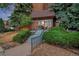 Condo entrance with lush landscaping, a secure entrance, and well-maintained steps at 4110 Hale Parkway Pkwy # 3J, Denver, CO 80220
