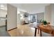 Light-filled living space with a sliding door to balcony, dining area, and galley kitchen at 4110 Hale Parkway Pkwy # 3J, Denver, CO 80220