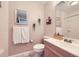 Cozy bathroom features a pedestal sink, decorative mirror, and neutral tones at 3260 47Th St # 108A, Boulder, CO 80301