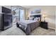 Cozy bedroom with balcony access, complete with a double bed, dresser, and nightstands at 3260 47Th St # 108A, Boulder, CO 80301