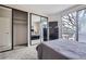 Bedroom with double bed, a large mirrored closet, balcony access, and a dresser with television at 3260 47Th St # 108A, Boulder, CO 80301