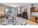 Comfortable living room with fireplace and access to the outdoor balcony with mountain views at 3260 47Th St # 108A, Boulder, CO 80301