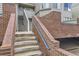 Exterior staircase with brick wall and blue railing for easy access to upper-level units at 3260 47Th St # 108A, Boulder, CO 80301