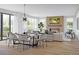 Open-concept living and dining area with fireplace, hardwood floors, and abundant natural light at 2778 Utica St, Denver, CO 80212