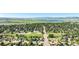 A neighborhood with green trees, houses, and a lake and mountains in the distance at 7780 S Kendall Blvd, Littleton, CO 80128