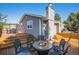 Inviting back deck featuring a fire pit and outdoor seating, perfect for entertaining guests at 7780 S Kendall Blvd, Littleton, CO 80128
