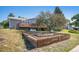 The backyard features a raised garden with tiered wood retaining walls at 7780 S Kendall Blvd, Littleton, CO 80128