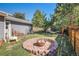 Cozy backyard with a brick fire pit and hammock at 7780 S Kendall Blvd, Littleton, CO 80128