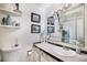 Well-lit bathroom with a large mirror, a white sink, and framed prints on the wall at 7780 S Kendall Blvd, Littleton, CO 80128
