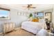 Spacious bedroom offering a ceiling fan and sun-filled windows, with a white duvet comforter at 7780 S Kendall Blvd, Littleton, CO 80128