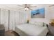 Cozy bedroom with a light blue duvet, a ceiling fan, and a coastal-themed painting at 7780 S Kendall Blvd, Littleton, CO 80128