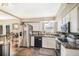 Modern kitchen with stainless steel appliances, granite countertops, and white cabinetry at 7780 S Kendall Blvd, Littleton, CO 80128