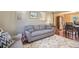 Inviting living room featuring hardwood floors, a stylish rug, and comfortable gray furniture at 7780 S Kendall Blvd, Littleton, CO 80128