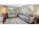 Comfortable living room with large window offering natural light and views of the surrounding greenery at 7780 S Kendall Blvd, Littleton, CO 80128