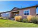 Landscaped backyard with healthy lawn, beautiful plantings, and a covered patio with home exterior at 3598 New Haven Cir, Castle Rock, CO 80109