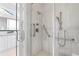 Accessible bathroom with a glass-enclosed shower, safety bars, and dual shower heads at 3598 New Haven Cir, Castle Rock, CO 80109