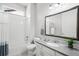 Well-lit bathroom features a shower-tub combination, large framed mirror and updated vanity with grey countertop at 3598 New Haven Cir, Castle Rock, CO 80109